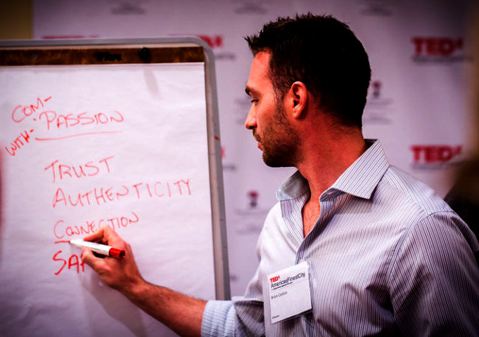 A picture of a man writing on a whiteboard